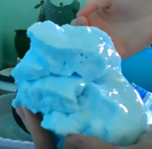 A picture of blue "glacier goo" being held.