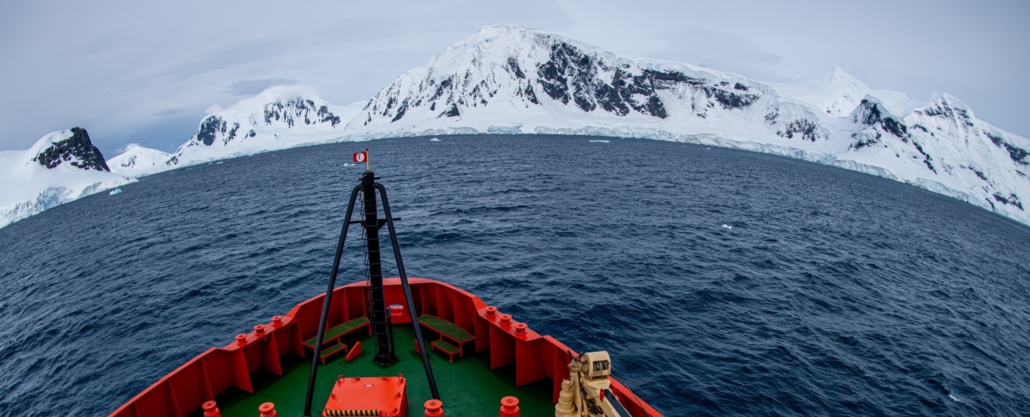 The mountainous coast of Antarctica as seen from the bow of the RV Gould.