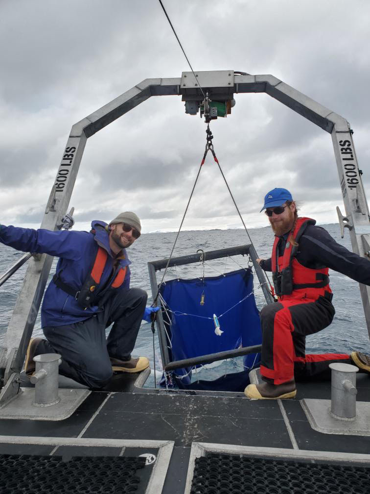 Andrew and Captain Matt on the stern of the R/V Hadar using a krill net to sample to the ocean
